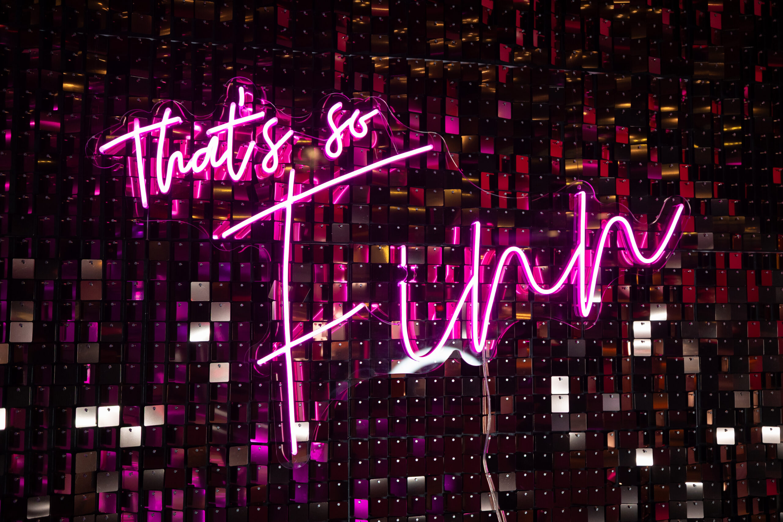 9JanBirch979A5880 - Bronson Hospitality Neon pink sign reading 'That's so' glowing over a dark purple mosaic wall backdrop.