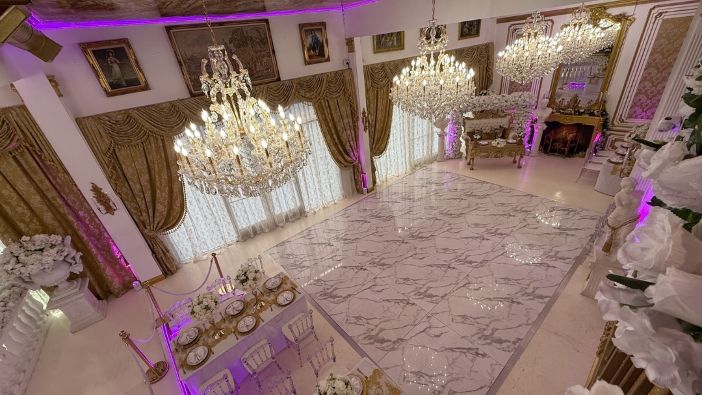 Glass Slipper Palace - Bronson Hospitality An elegant ballroom at Glass Slipper Palace featuring grand crystal chandeliers, luxurious décor, marble-style flooring, and a sophisticated indoor event setting