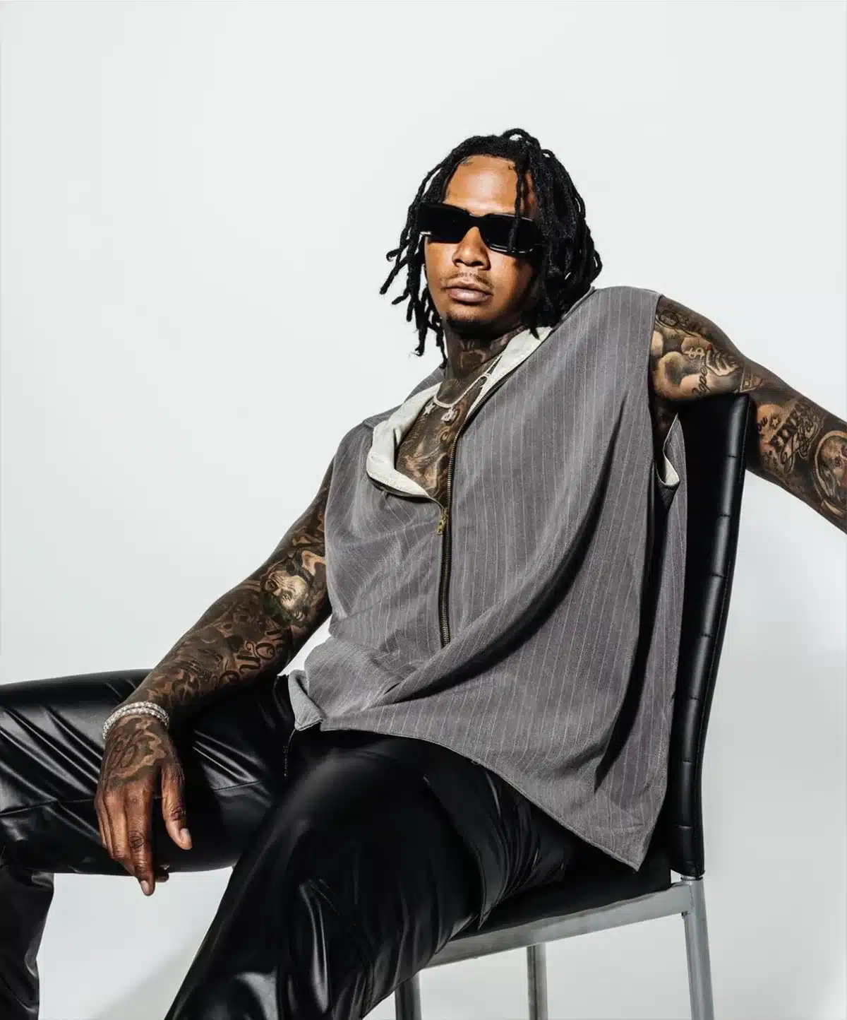 Editorial photoshoot of model in tailored streetwear seated on chair, showcasing Studio Eleven43's LED stage and soundstage rental in Los Angeles