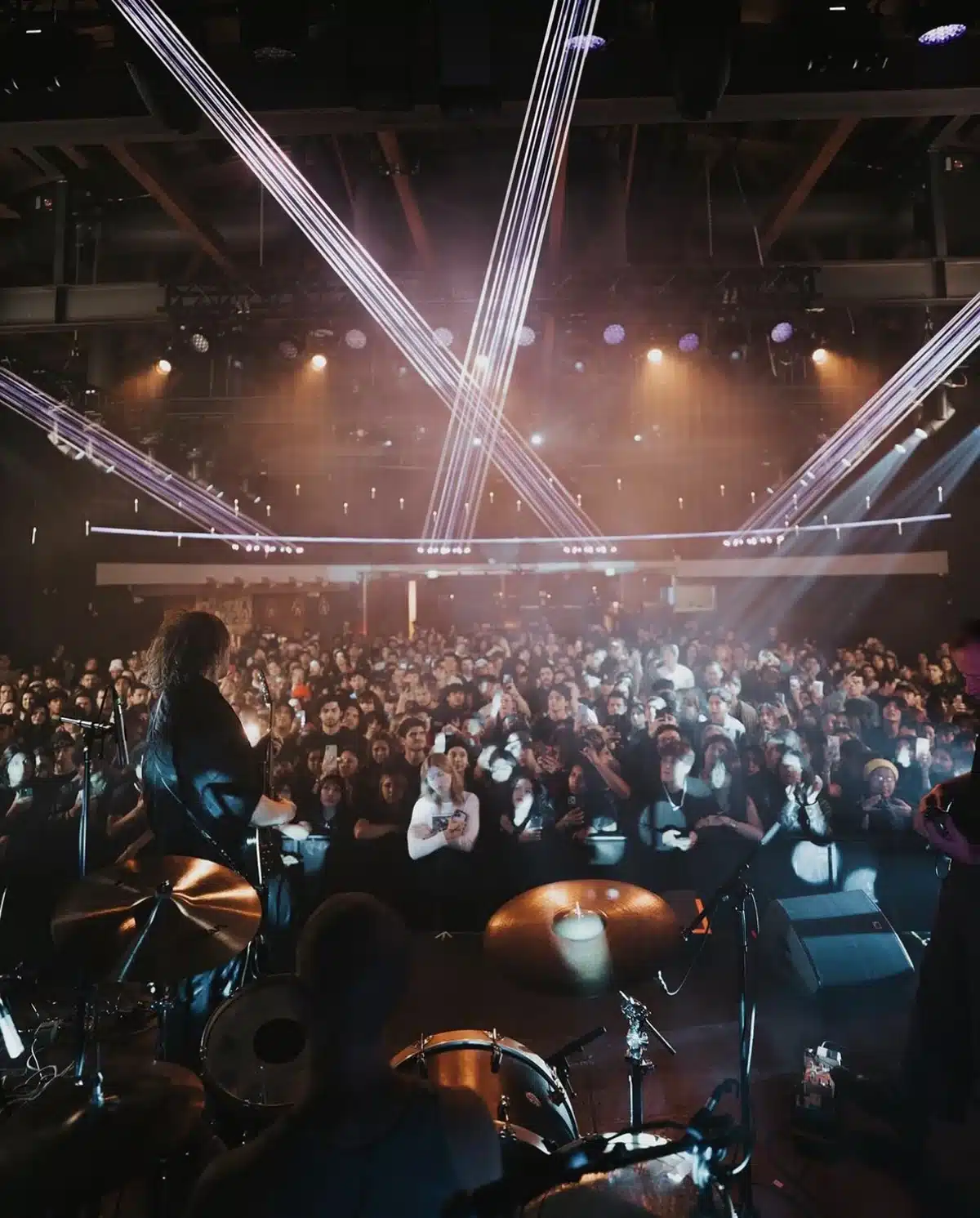 Wide-angle view of live band performing to packed crowd with laser lighting at Vermont Hollywood